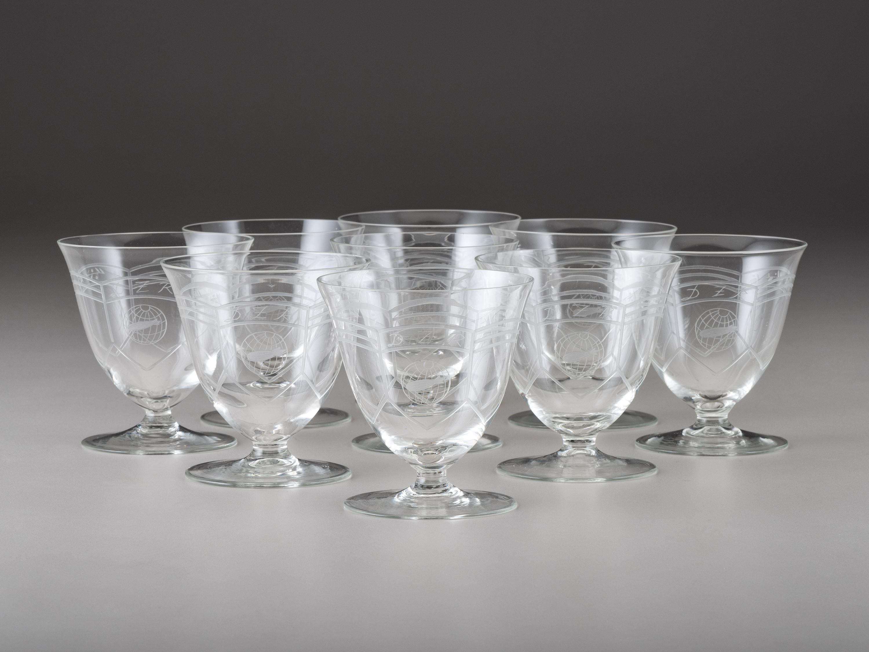 [TRANSPORTATION] - [ZEPPELIN]. Set of Deutsche Zeppelin-Reederei porcelain with dinner plates, salad plates, and sherbet glasses.