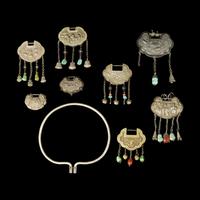 A Chinese Silver Necklace and Eight Chinese Silver Ruyi Lock-Form Pendants, Qing Dynasty 清 銀項圈一及銀如意頭形長命鎖一組八件