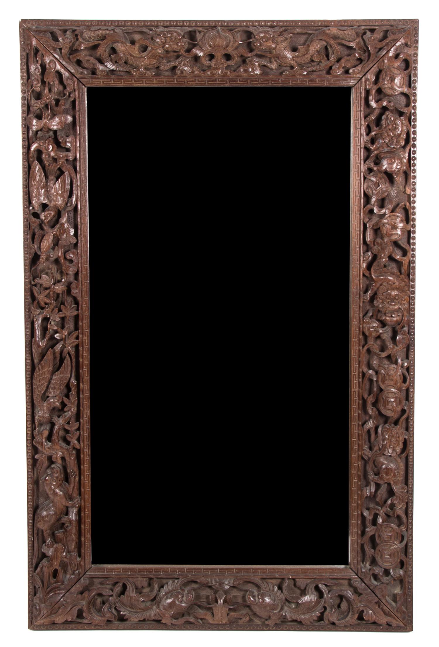 An Indonesian Carved Teak Mirror Height 55 x width 35 inches. — 19TH CENTURY
