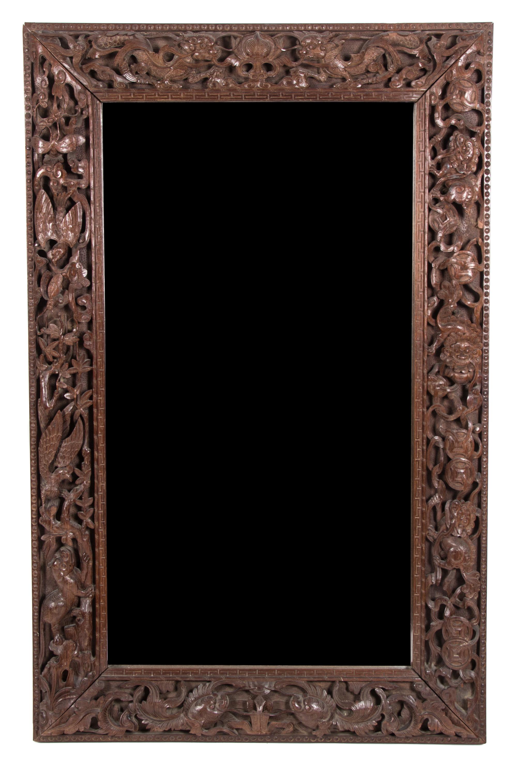An Indonesian Carved Teak Mirror Height 55 x width 35 inches. — 19TH CENTURY