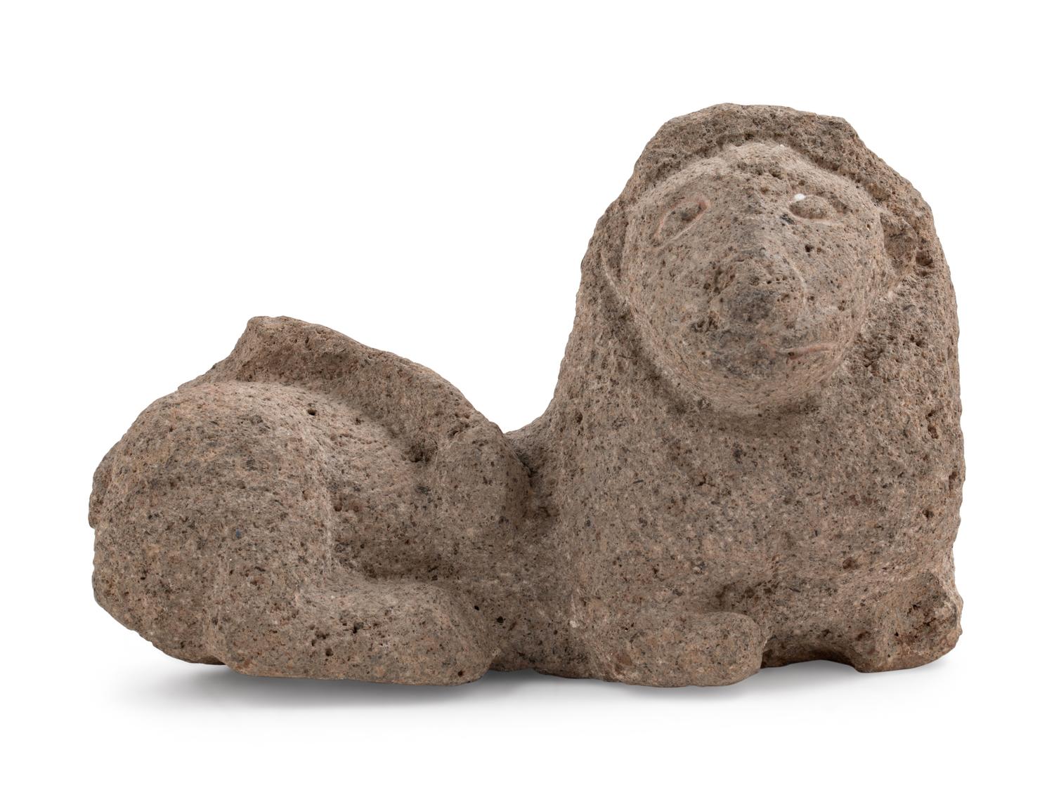 A Carved Granite Figure of a Reclining Lion — 19TH/20TH CENTURY