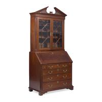 A Chippendale Carved Mahogany Desk-and-Bookcase