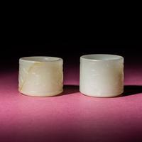 Two Chinese White Jade 'Animal' Archer's Rings, 18th Century — 清中期 白玉刻動物紋扳指兩枚