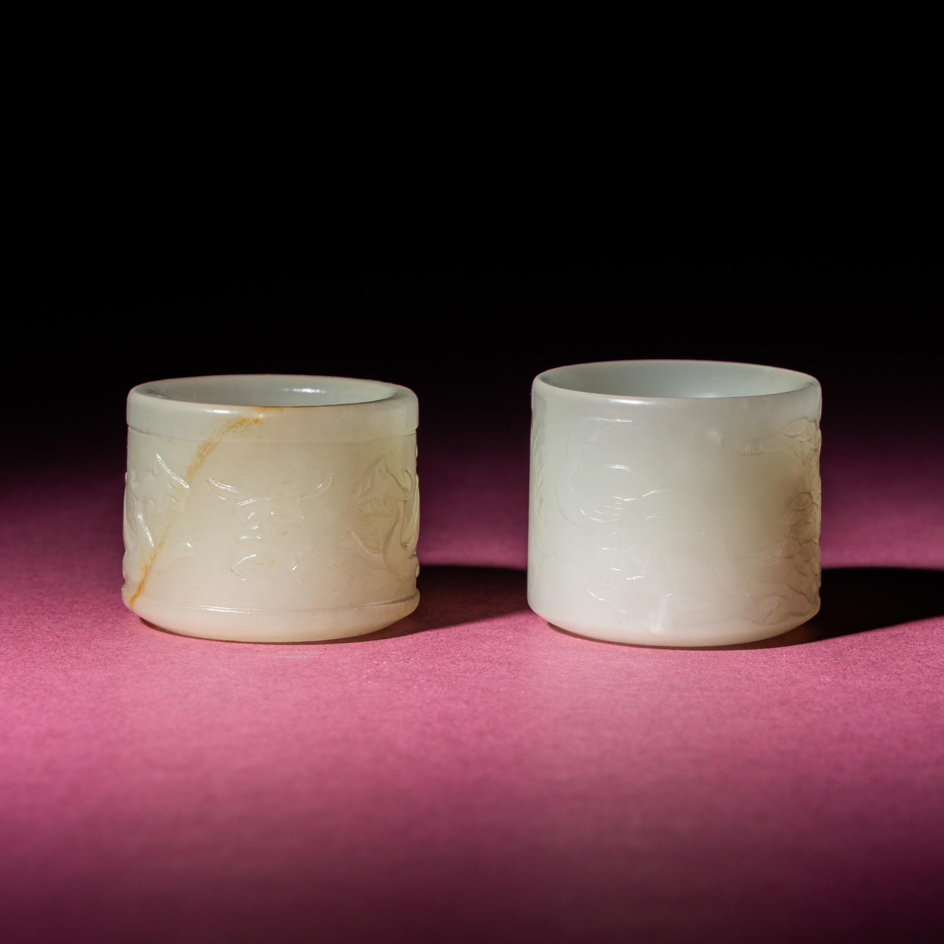 Two Chinese White Jade 'Animal' Archer's Rings, 18th Century — 清中期 白玉刻動物紋扳指兩枚