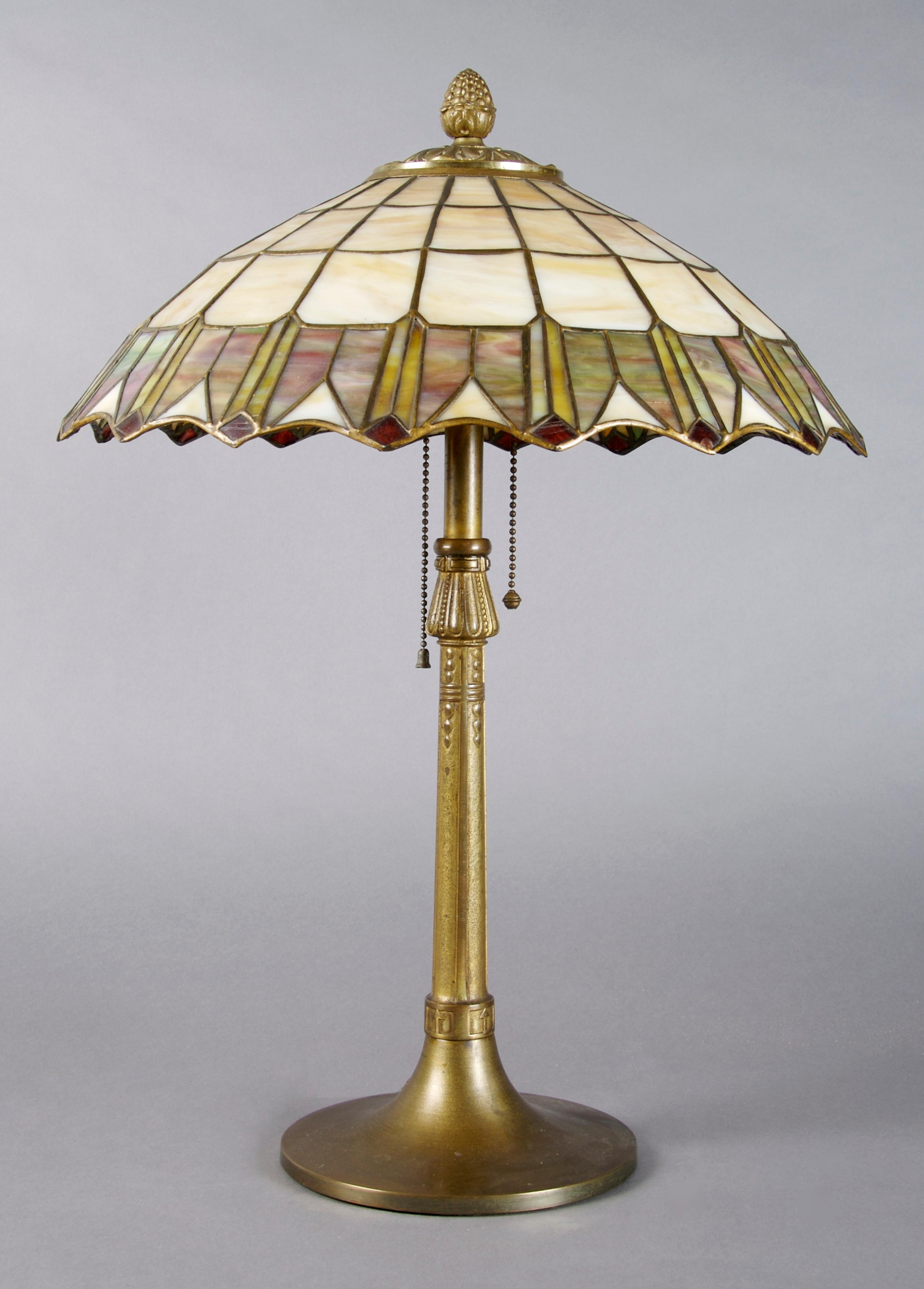 An American Leaded Glass Lamp, Height 21 inches, diameter of shade 15 1/2 inches.