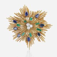 An 18K yellow gold, sapphire, diamond, and emerald starburst brooch Alessandria, Italy