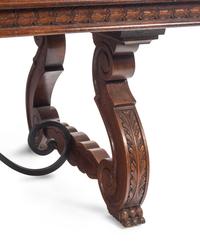 A Spanish Baroque Style Iron-Mounted Walnut and Elm Trestle Table