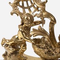 A pair of Louis XVI style gilt bronze chenets late 19th century