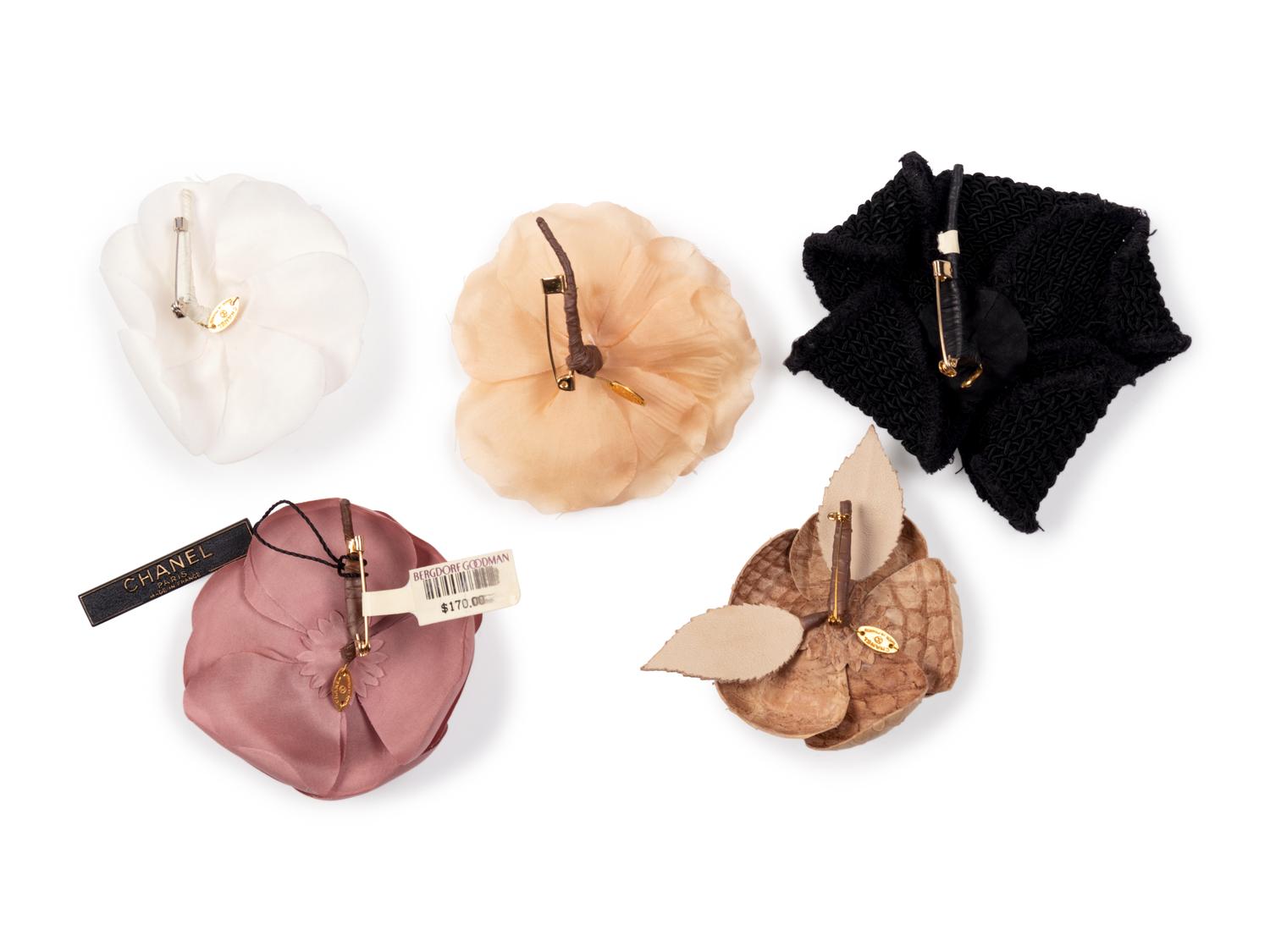 Six Chanel Brooches/Pins: Four Textile, One Snake Skin, One Metal