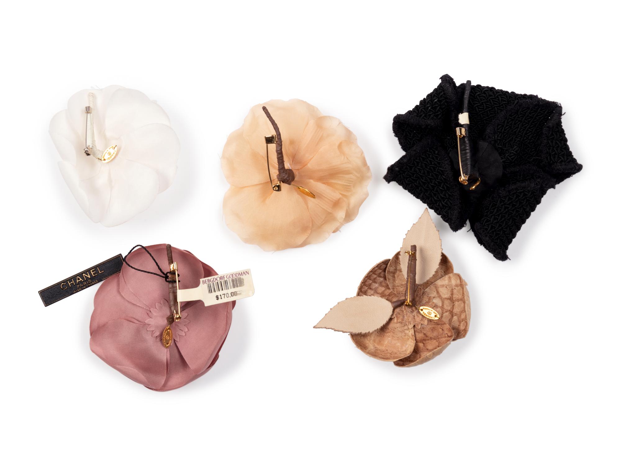 Six Chanel Brooches/Pins: Four Textile, One Snake Skin, One Metal