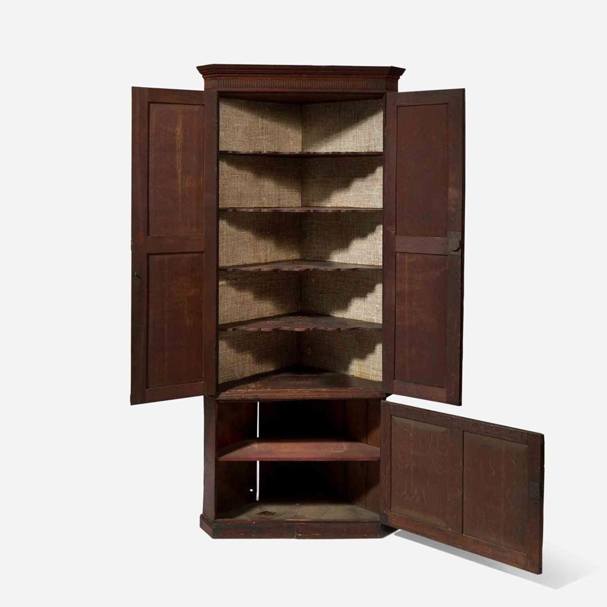 A George III carved oak corner cupboard late 18th century