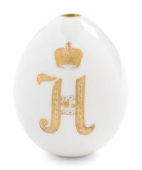 A Nicholas II Imperial Porcelain Factory Parcel-Gilt Porcelain Easter Egg