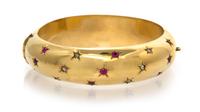 An 18 Karat Yellow Gold, Ruby and Diamond Bangle Bracelet, 18.90 dwts.