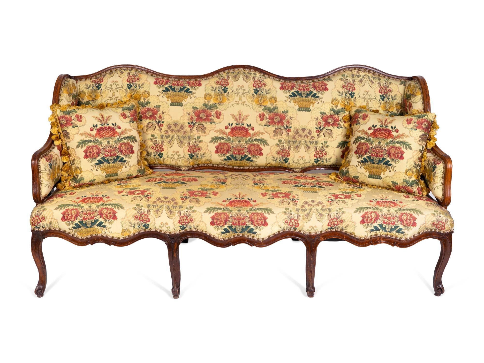 A Louis XV Provincial Walnut and Oak Canapé à Oreilles — THIRD QUARTER 18TH CENTURY