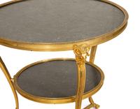 A Pair of French Empire Style Gilt Bronze and Black Marble Two Tier Gueridon Tables