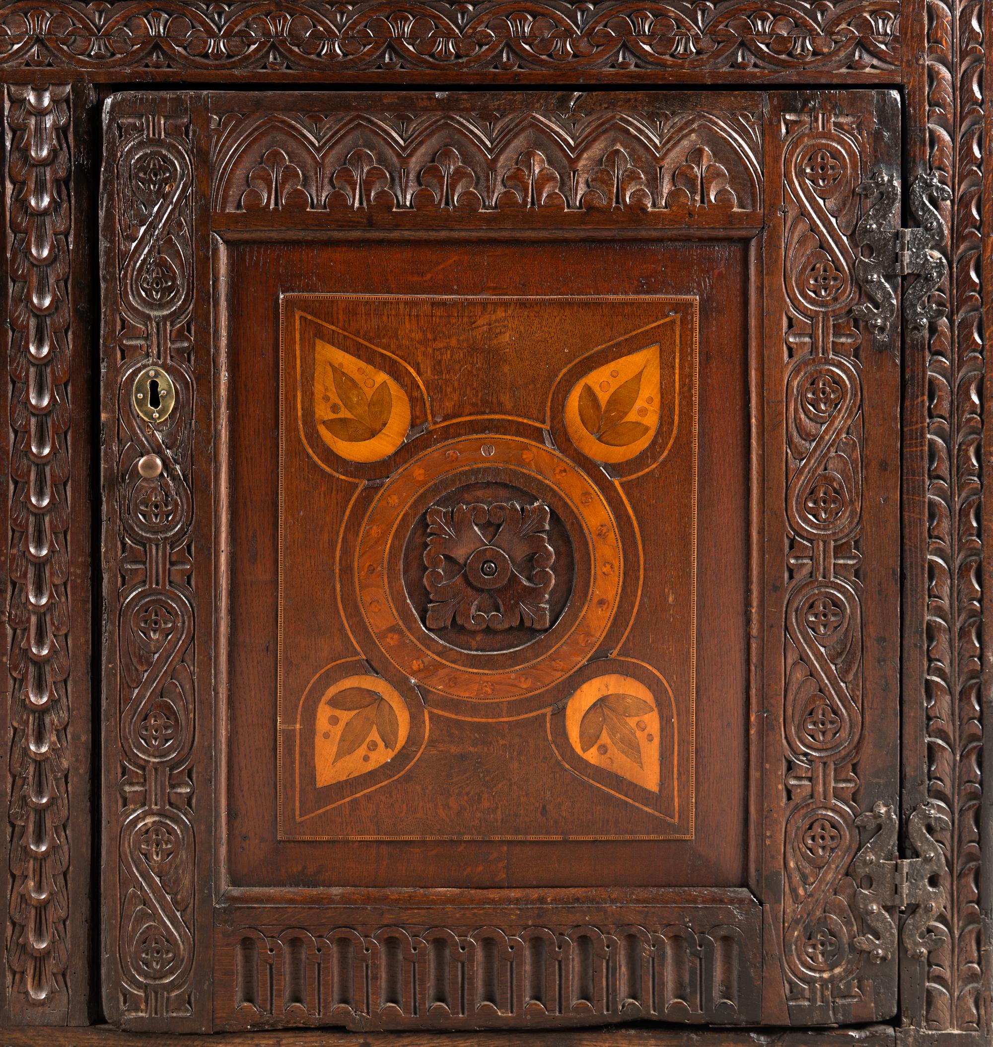 A Jacobean Carved Oak and Marquetry Court Cupboard