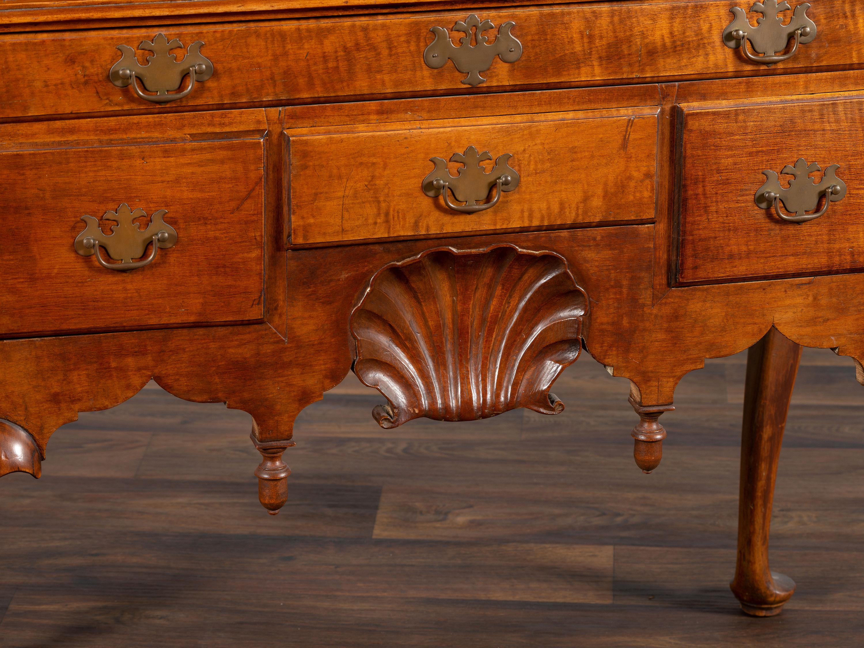 A Queen Anne Shell-Carved and Figured Maple Flat-Top High Chest of Drawers