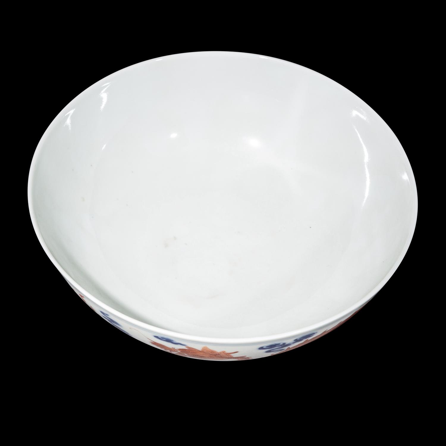 A Chinese Iron Red Decorated Underglaze Blue Porcelain 'Dragons' Bowl