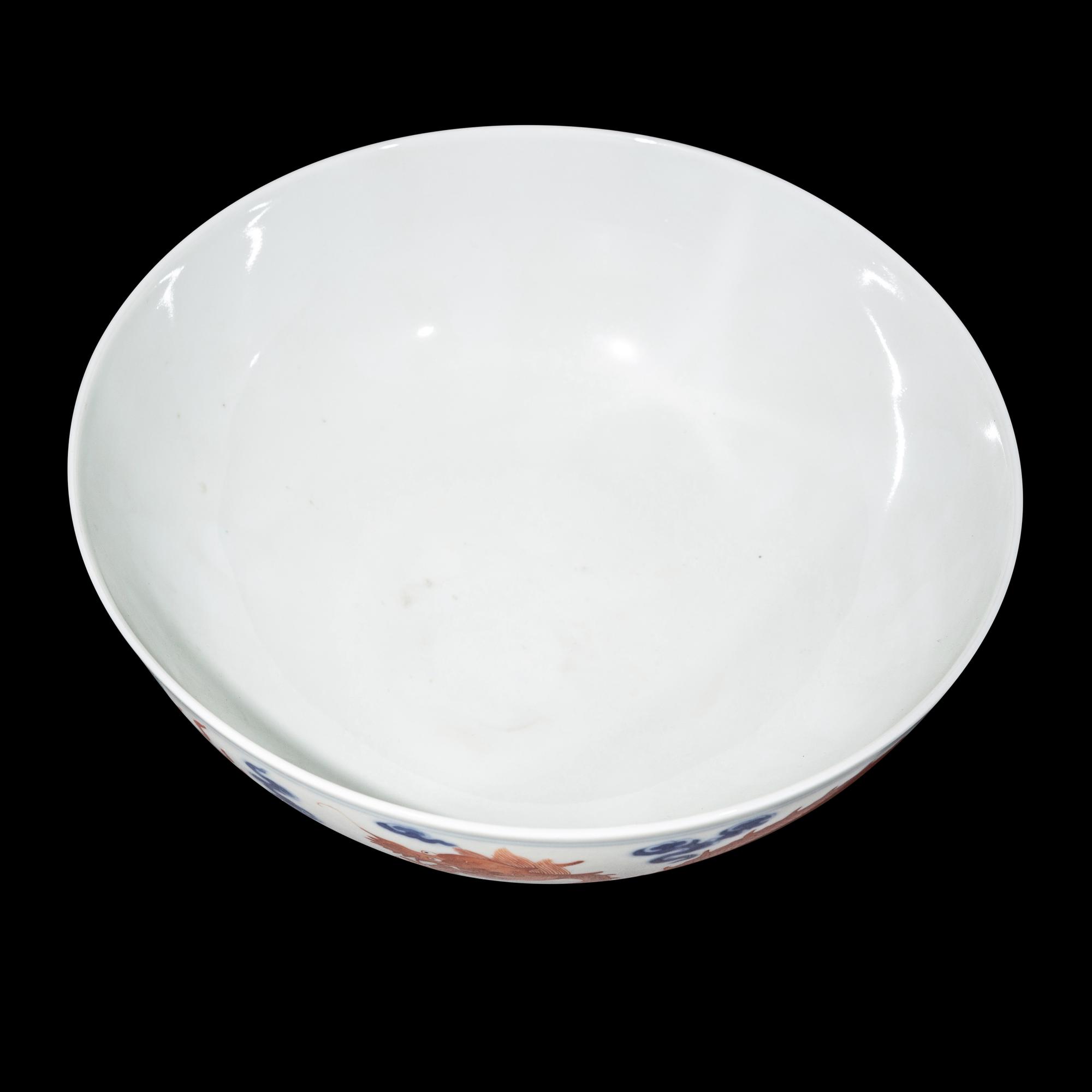 A Chinese Iron Red Decorated Underglaze Blue Porcelain 'Dragons' Bowl