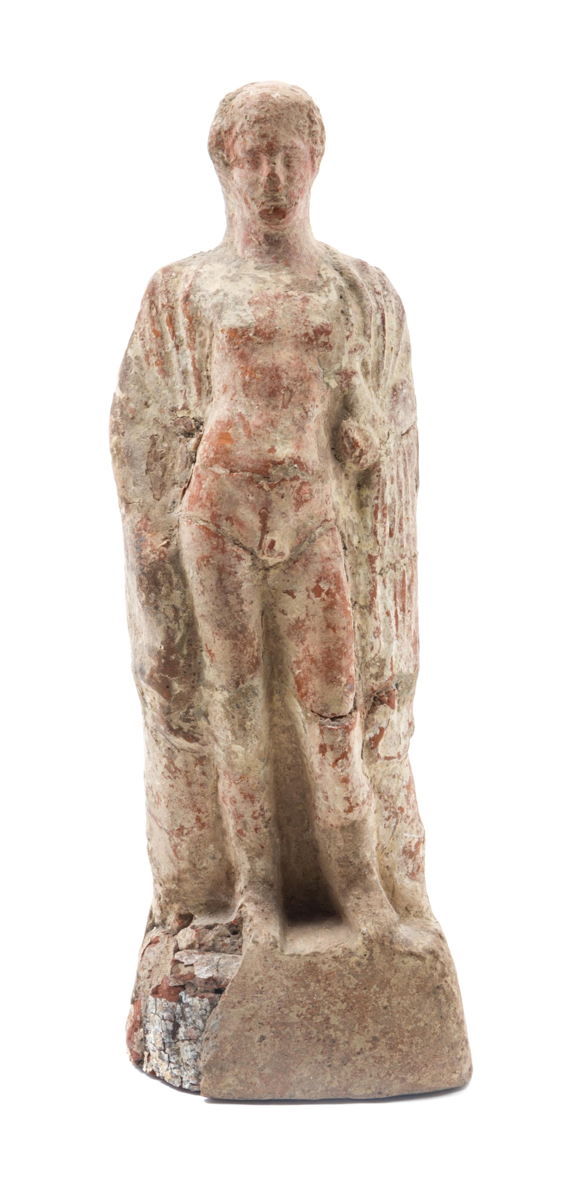 A Boeotian Terra Cotta Figure of Young Man Height 9 1/2 inches. — CIRCA FOURTH/FIFTH CENTURY B.C.