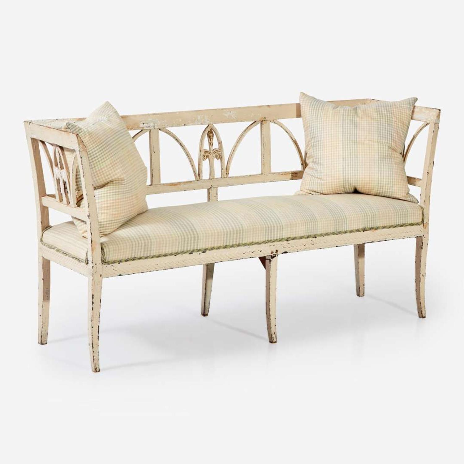 A Northern European cream-painted carved wood settee late 19th / early 20th century