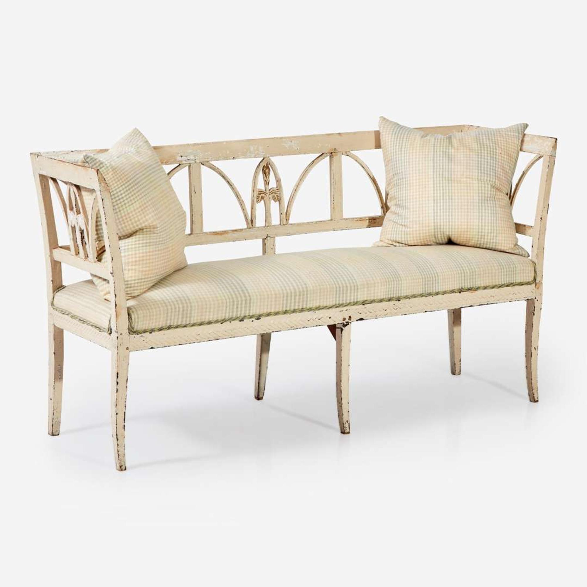 A Northern European cream-painted carved wood settee late 19th / early 20th century