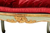 A Pair of Louis XV Green-Painted and Parcel-Gilt Cane Seat Window Benches