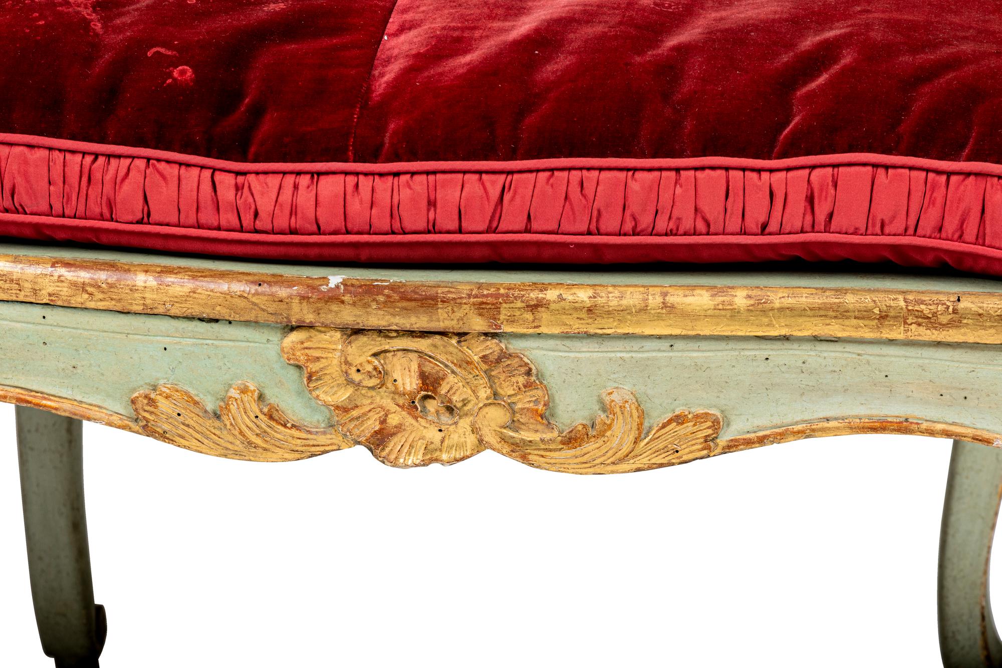 A Pair of Louis XV Green-Painted and Parcel-Gilt Cane Seat Window Benches