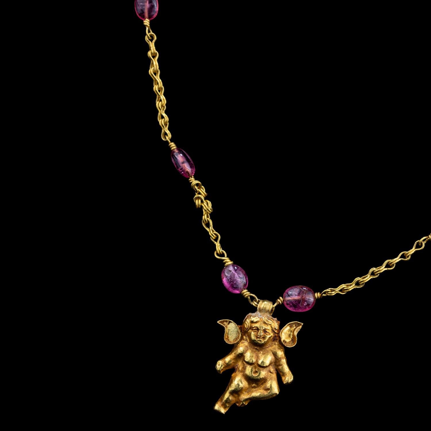 A Hellenistic Gold Eros Pendant — with a modern gold and pink spinel beads chain