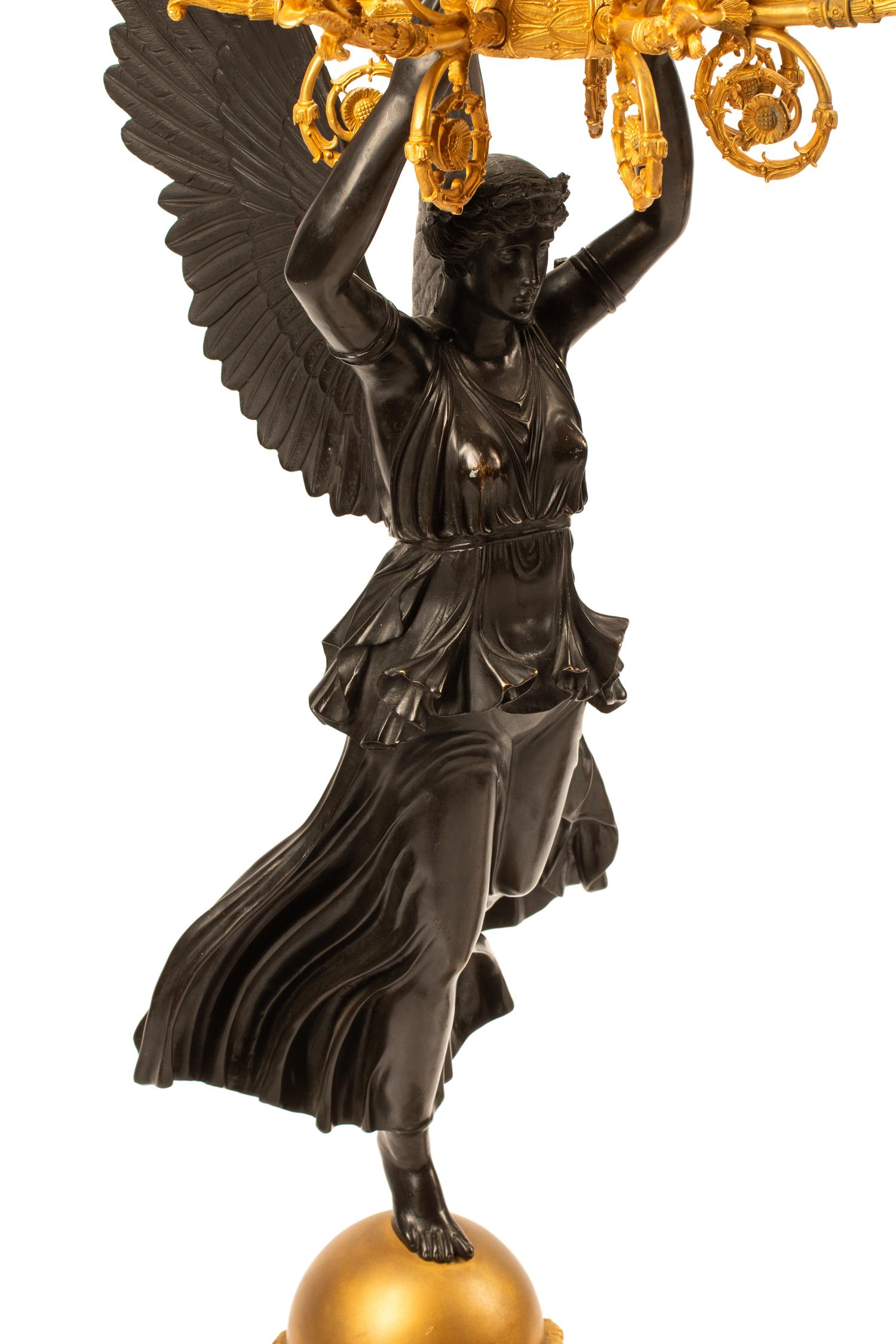 A Pair of Monumental Empire Style Gilt and Patinated Metal Seven-Light Figural Candelabra