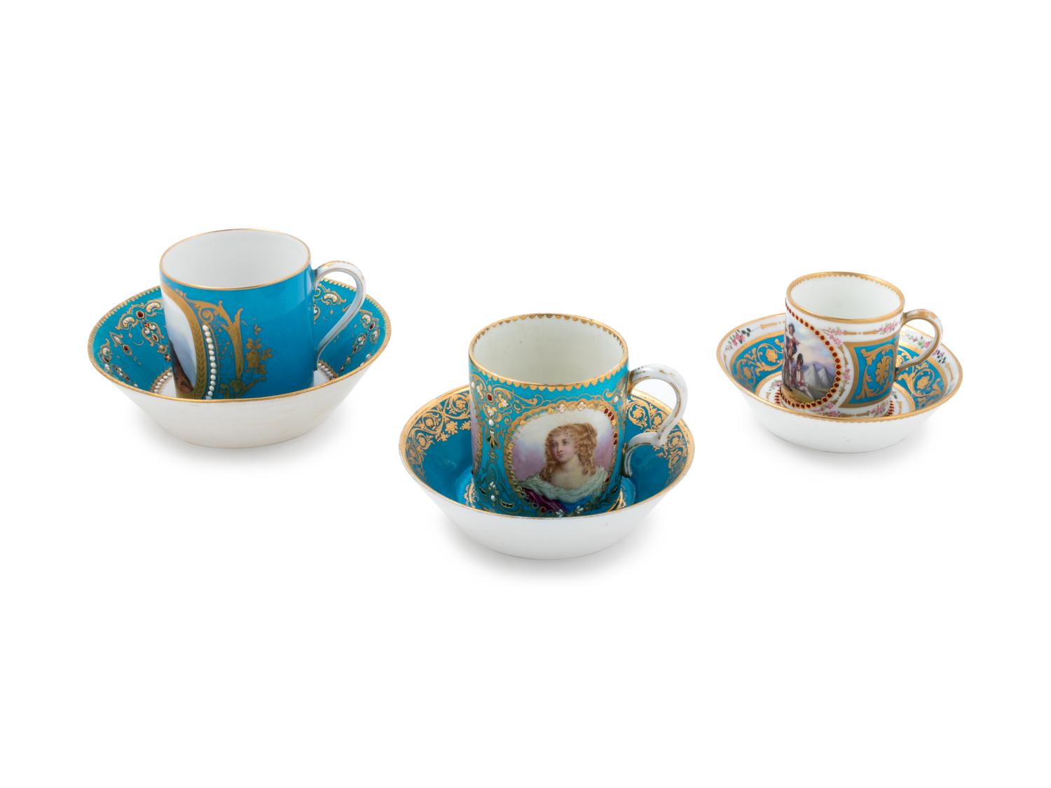 Three Sèvres Painted, Parcel Gilt and "Jeweled" Celeste Blue-Ground Porcelain Teacups and Saucers