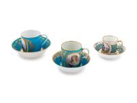 Three Sèvres Painted, Parcel Gilt and "Jeweled" Celeste Blue-Ground Porcelain Teacups and Saucers