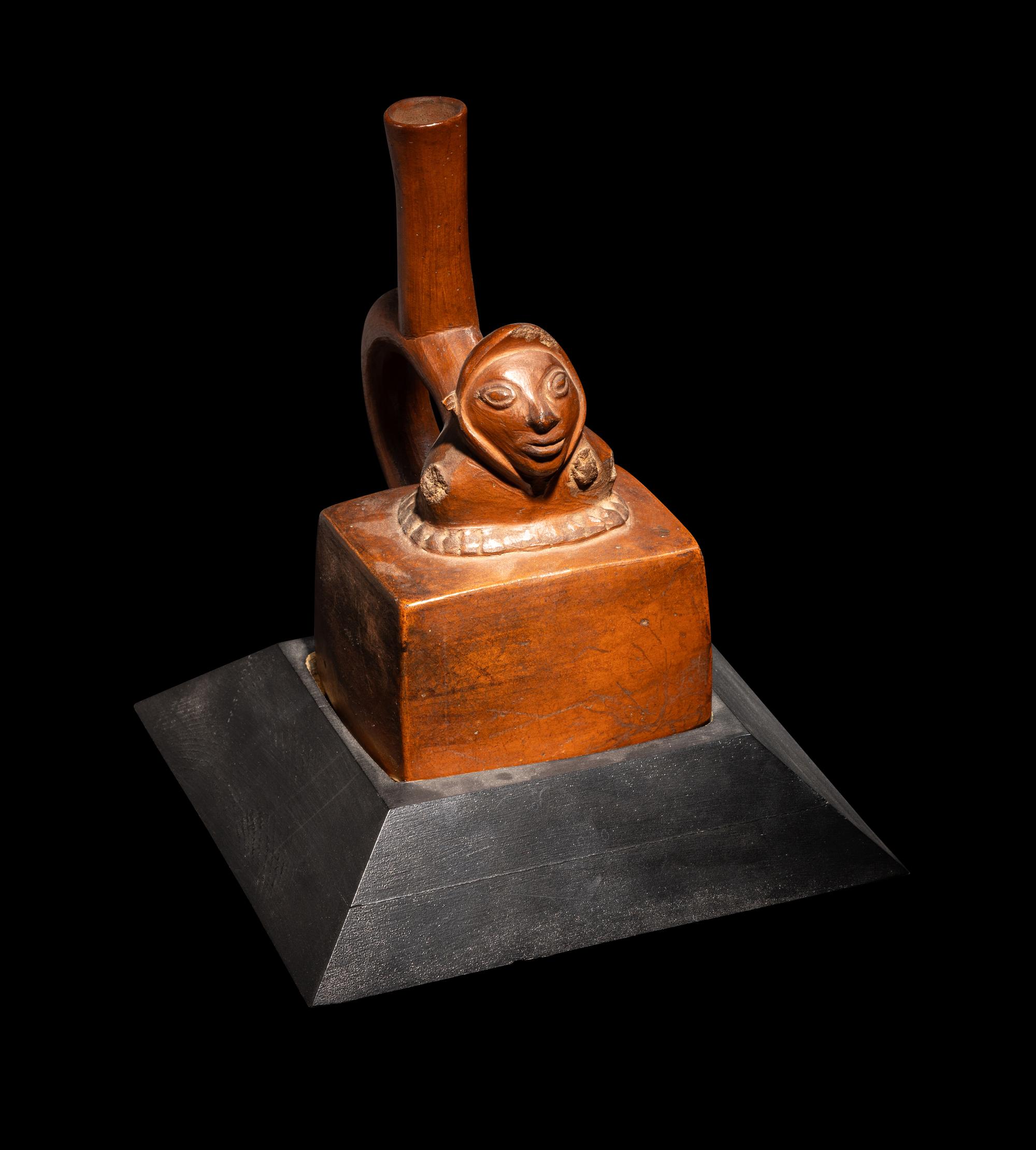 A Chimu-Inca Redware Stirrup Vessel with Squared Body and Human Figure