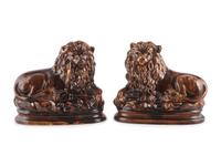 A Pair of Recumbent Lion Figures in Rockingham Glaze