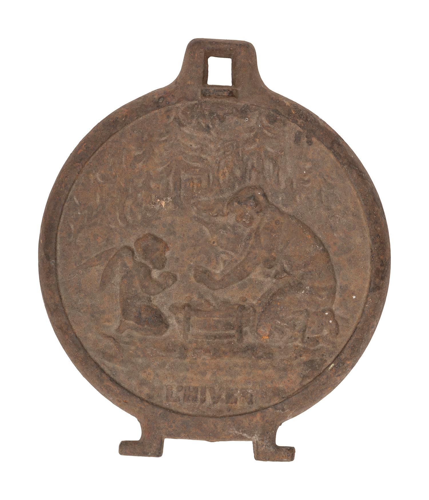 A Pair of Cast Iron Kettle Toppers and Two Trivets