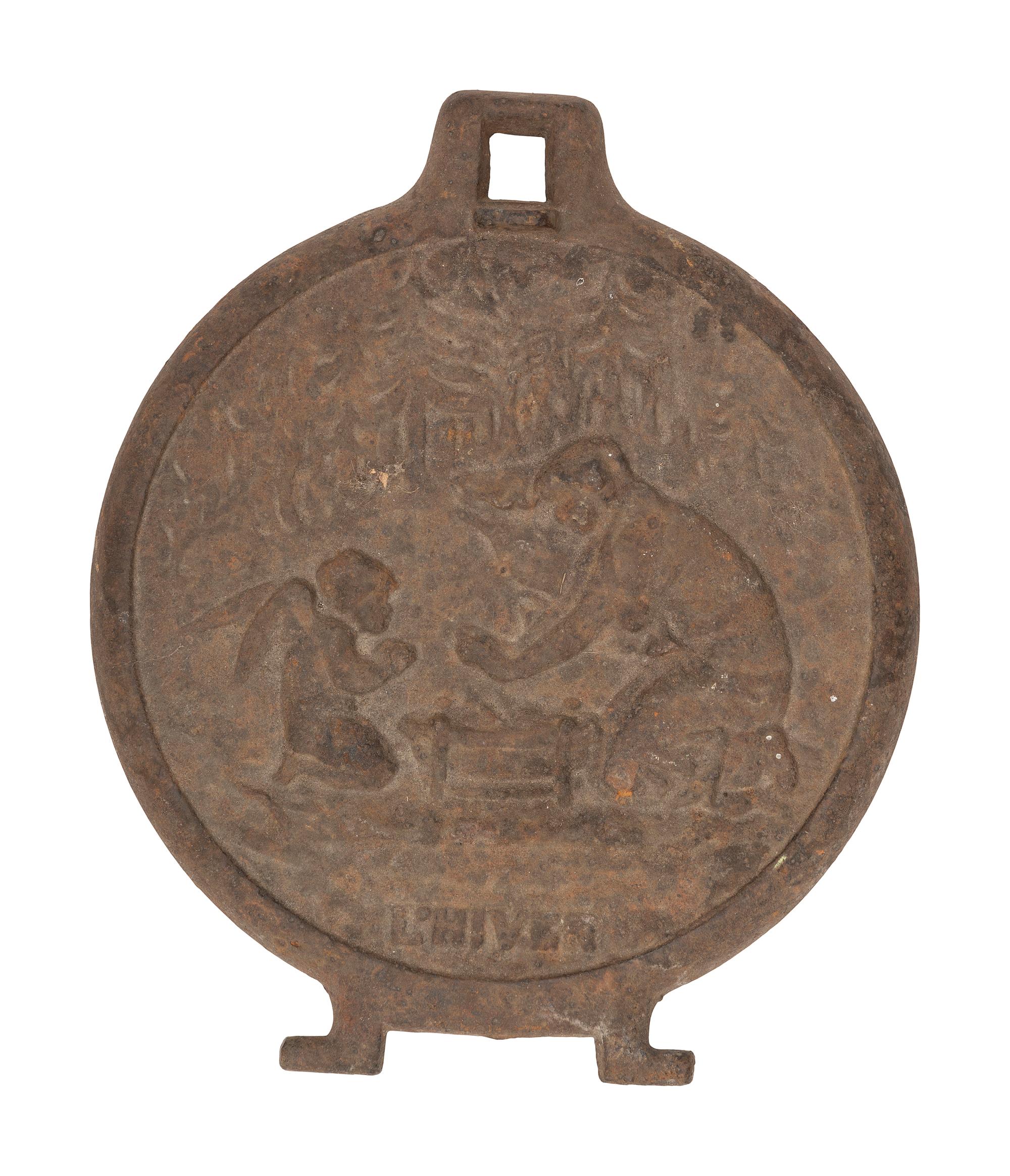 A Pair of Cast Iron Kettle Toppers and Two Trivets