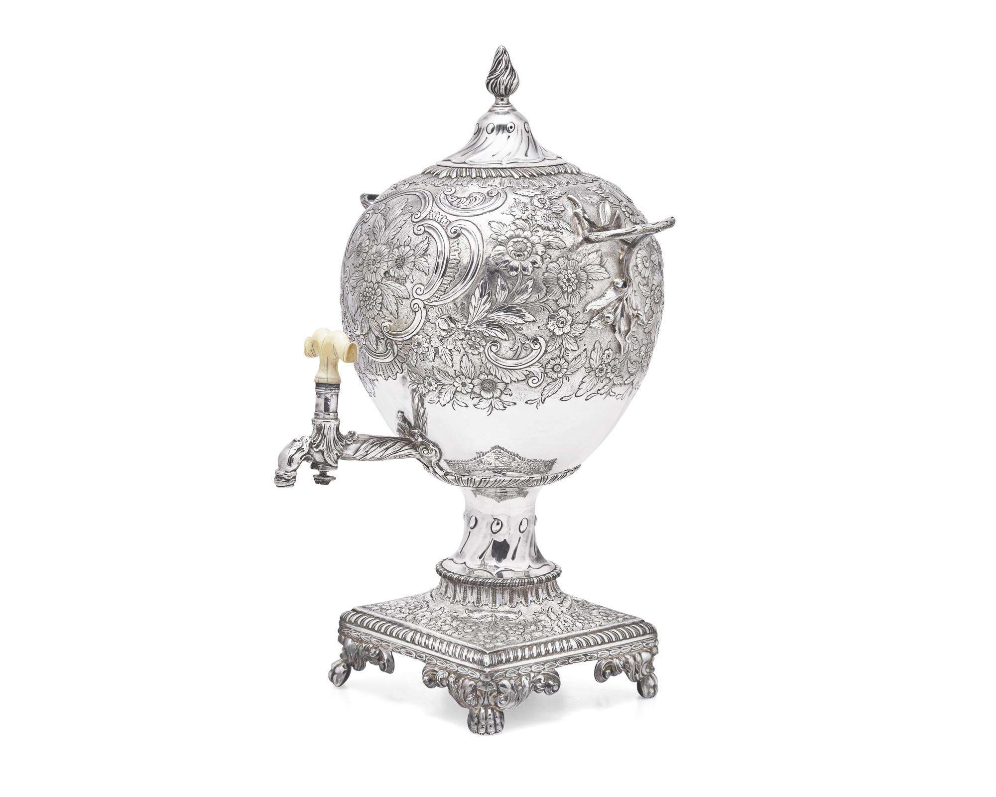 A George III sterling silver floral repoussé hot water urn, maker's mark rubbed, London, 1766