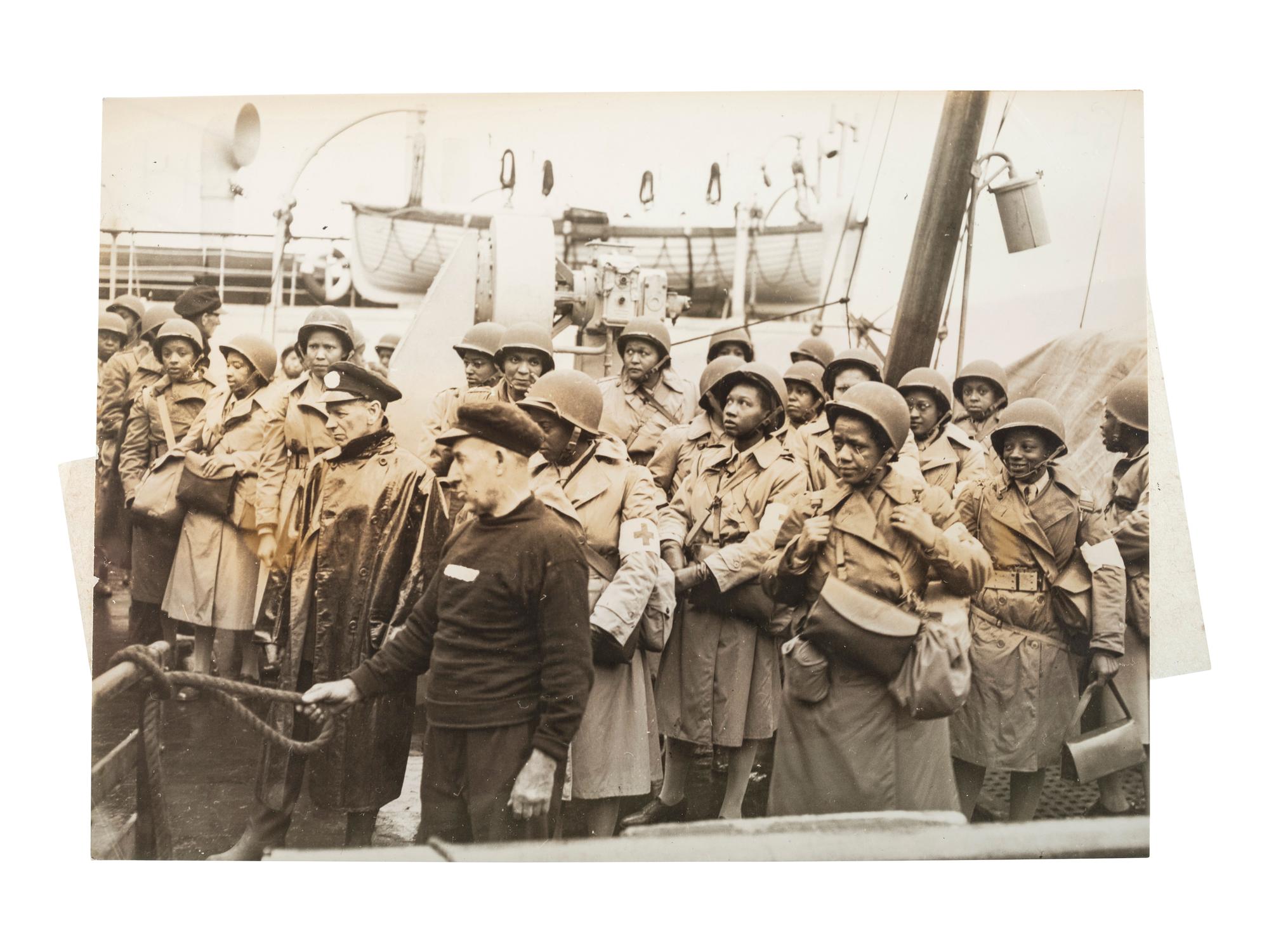 [WORLD WAR II & VIETNAM]. A group of 14 snapshots including portraits of prize fighter Toikey Thompson and black female combat nurses, including: