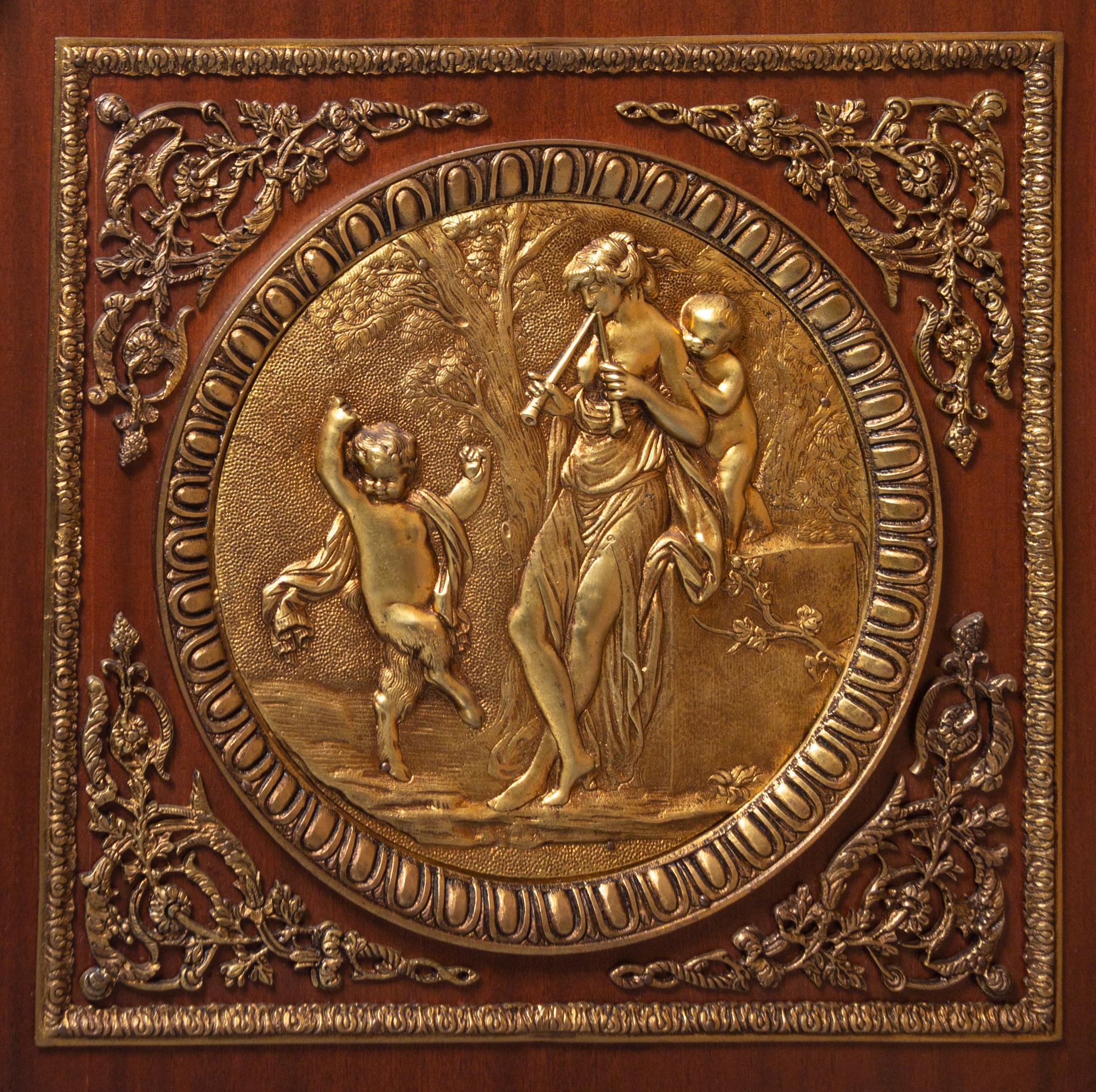A Louis XVI Style Gilt Bronze Mounted Mahogany Marble-Top Commode à Vantaux, after the Model by Guillaume Benneman