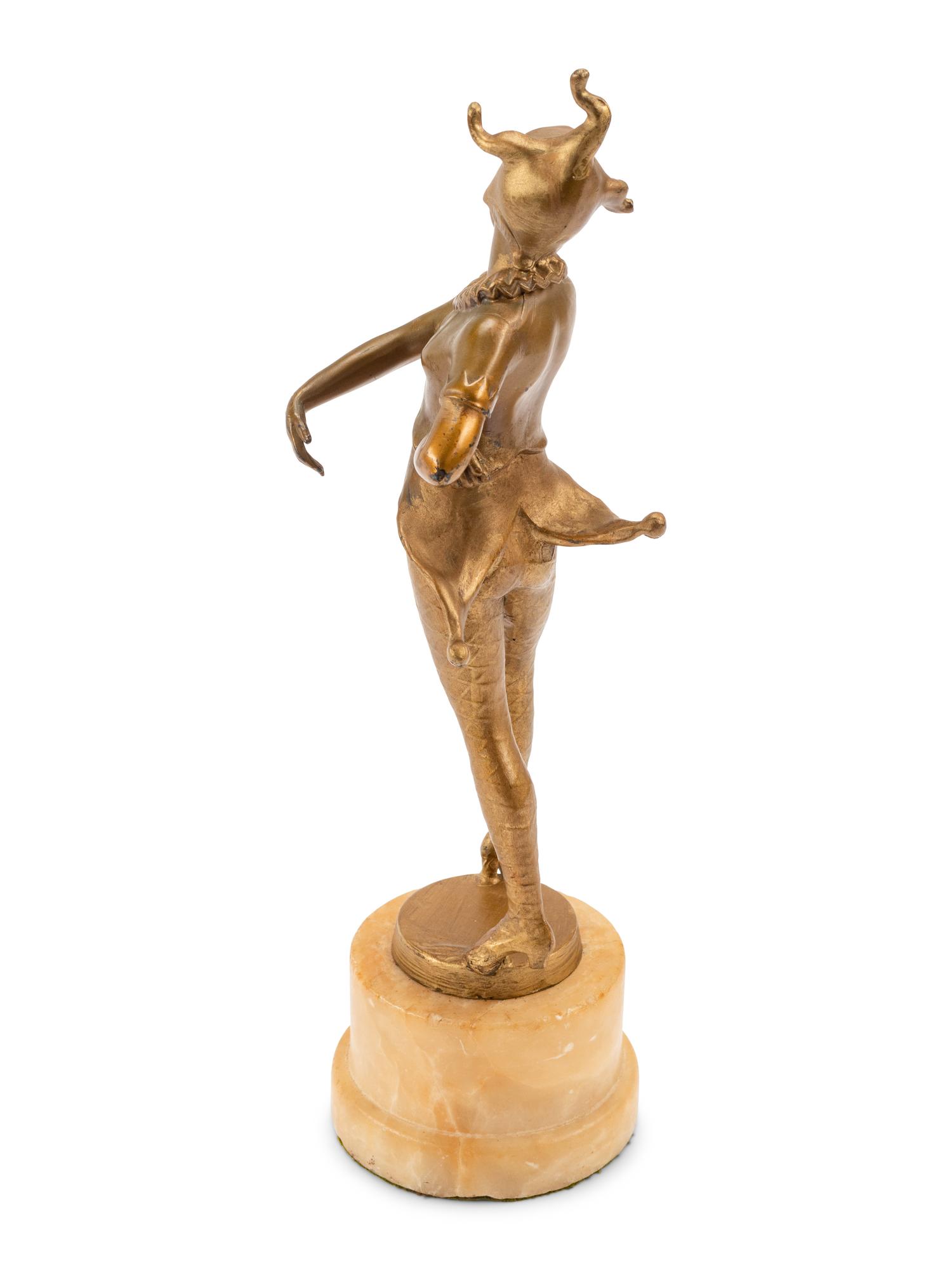A French Gilt Bronze Figure of a Harlequin on an Onyx Base