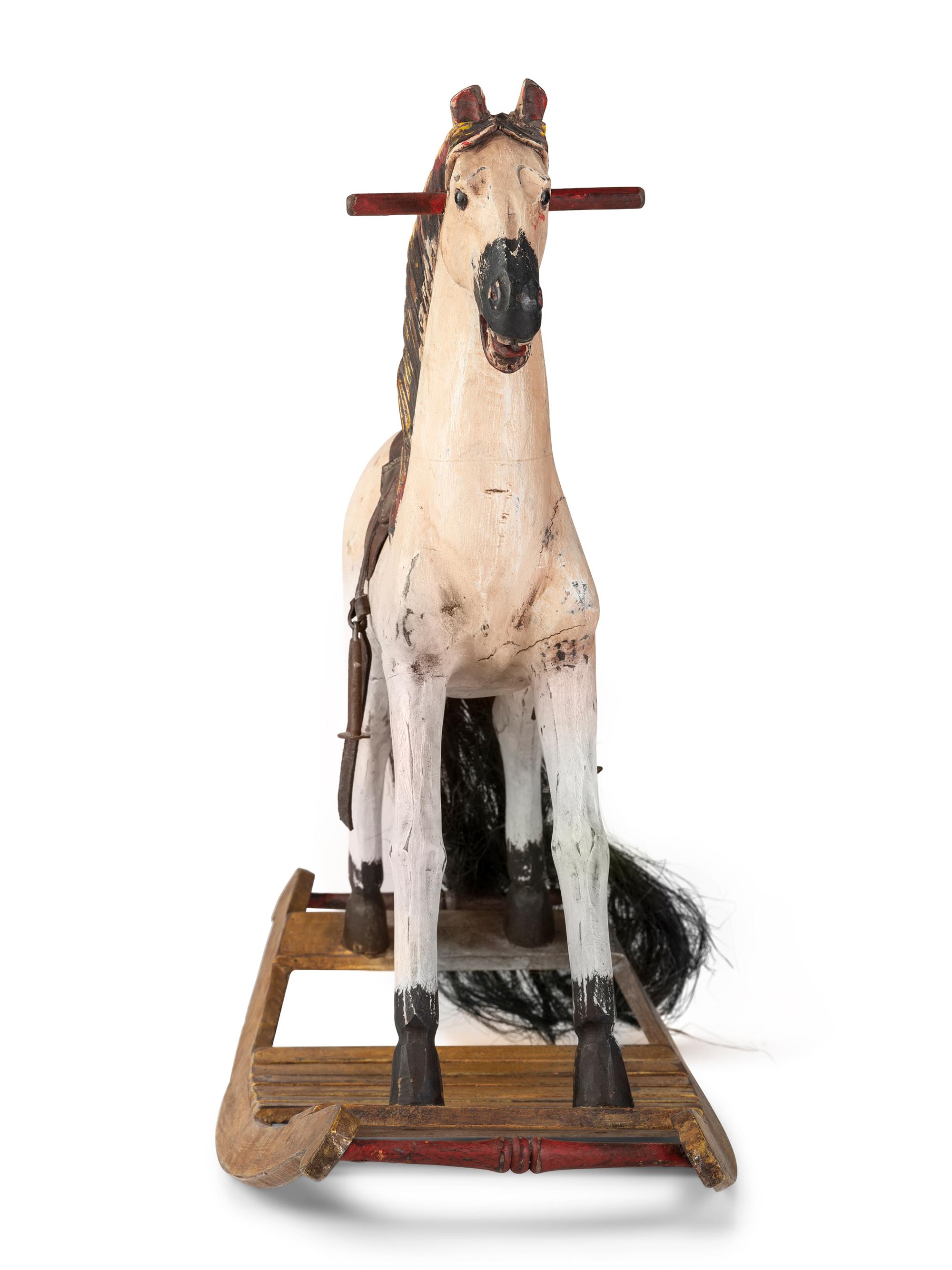 A Carved and Painted Wooden Rocking Horse