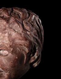 A Roman Rosso Antico Head of a Young Satyr