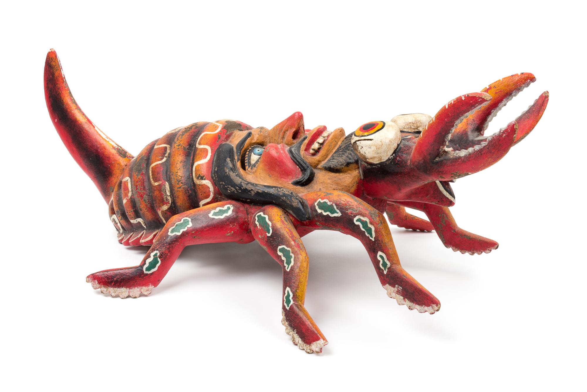 A Mexican Polychromed Wood Mask Height 30 1/2 inches.