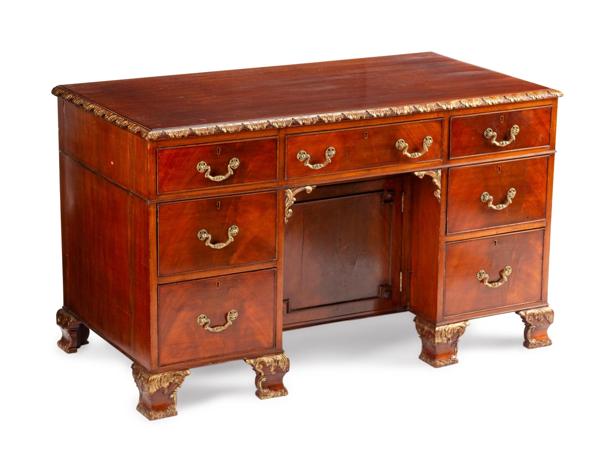 A George III Style Parcel-Gilt Mahogany Kneehole Desk — LATE 19TH/EARLY 20TH CENTURY