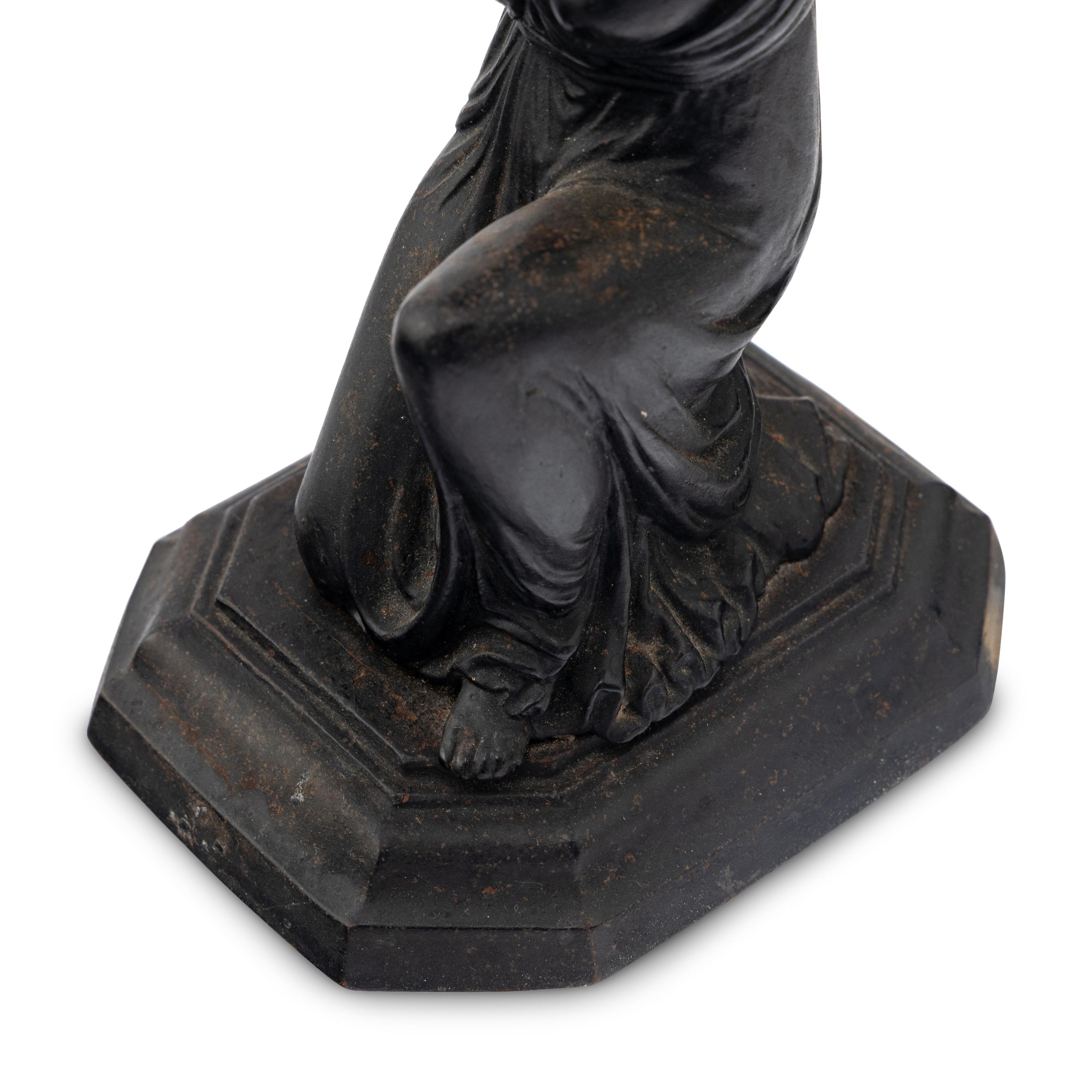 A Pair of Grand Tour Patinated Metal Figural Candlesticks