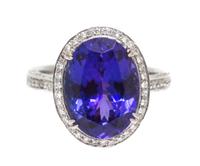 An 18 Karat White Gold Oval Cut Tanzanite and Diamond Ring, 5.10 dwts.