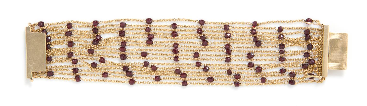 An 18 Karat Yellow Gold and Garnet Multi Strand Bracelet, French, 29.60 dwts.