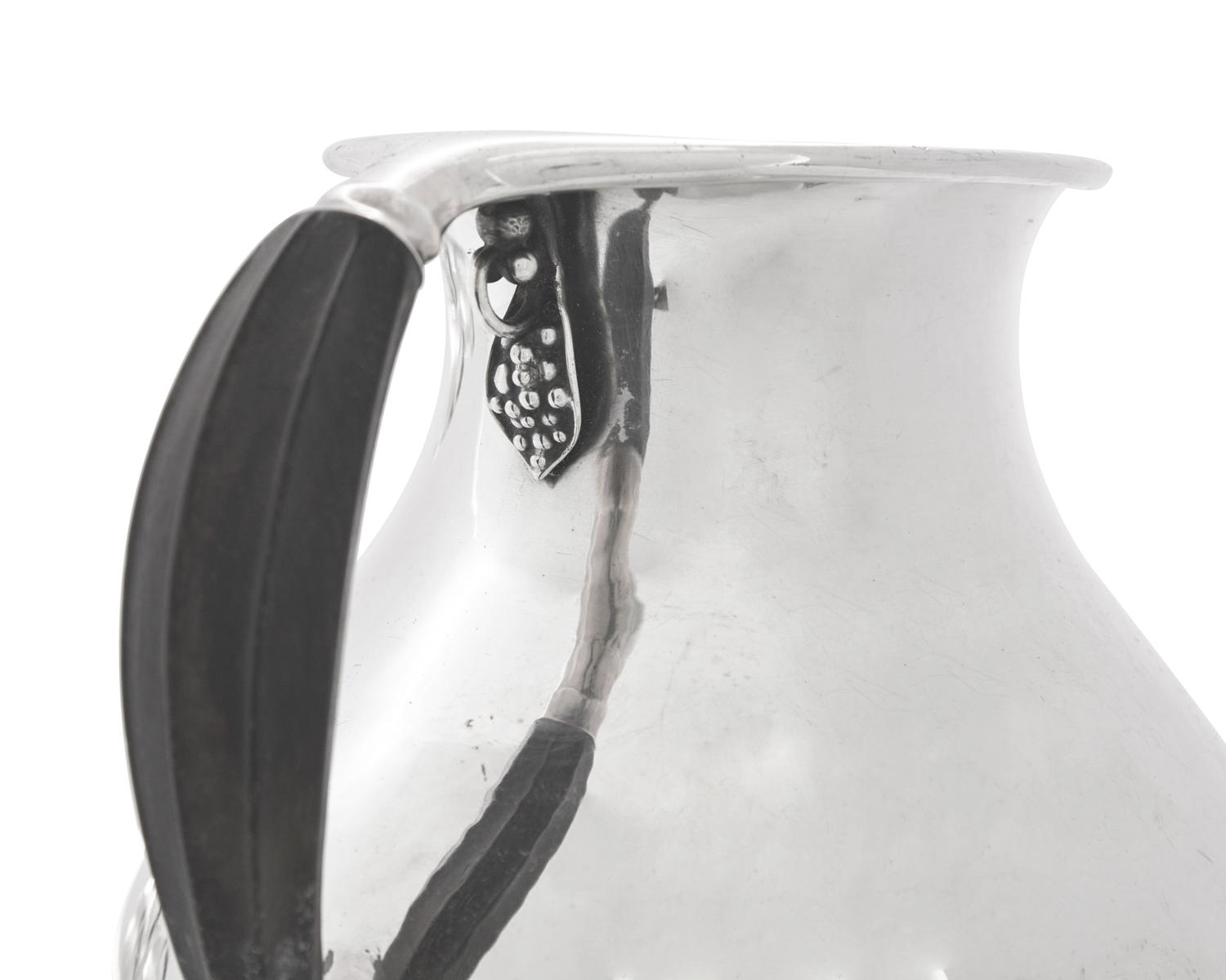 A Group of Four Georg Jensen Silver Pitchers