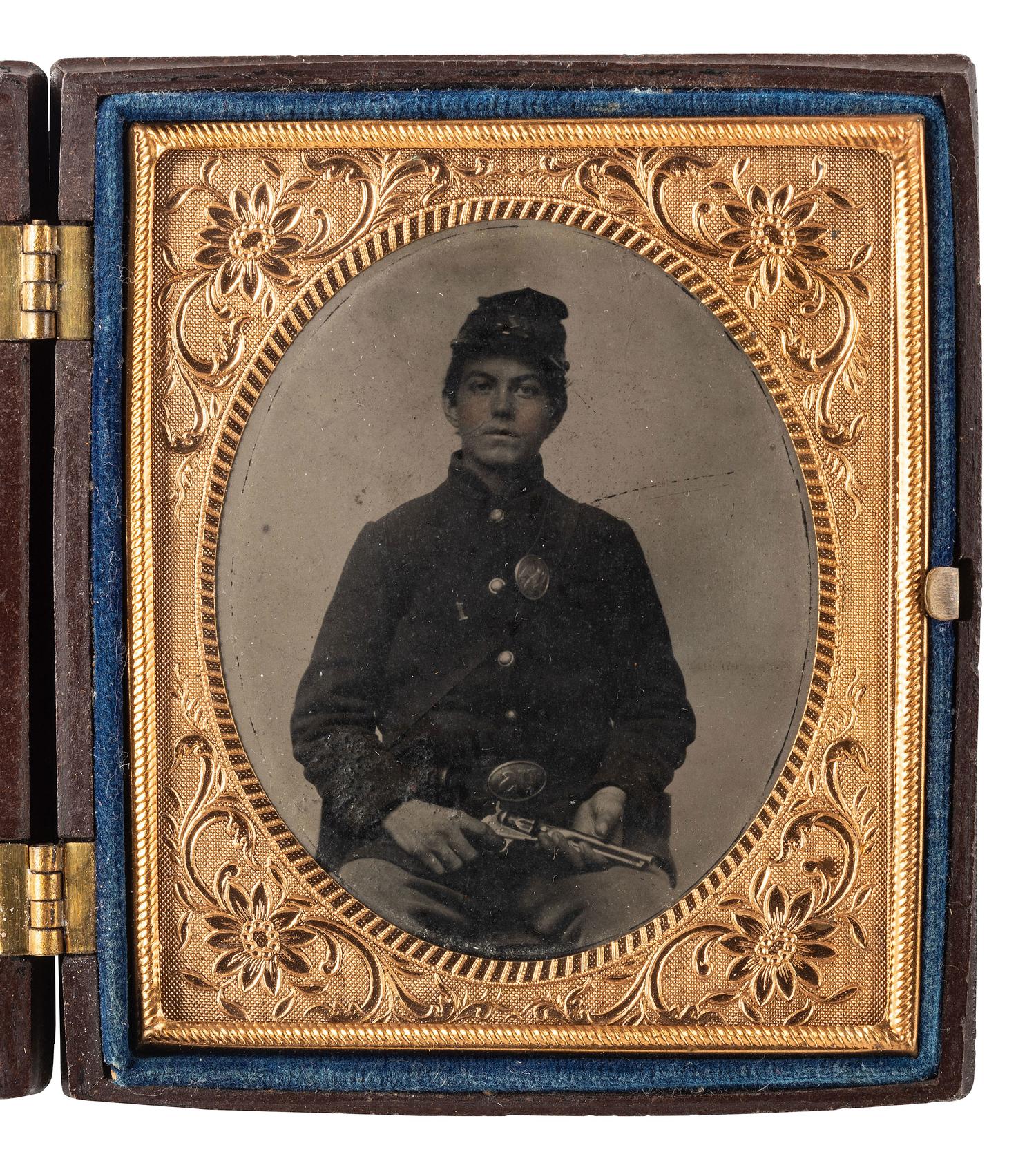 [CIVIL WAR]. 3 tintype portraits of armed soldiers housed in figural Union cases.