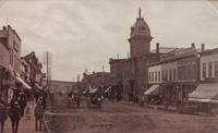 A group of three photographs (3647. Miners at Home; Untitled (main street); 2209. Dug Out - Bluer River Valley)